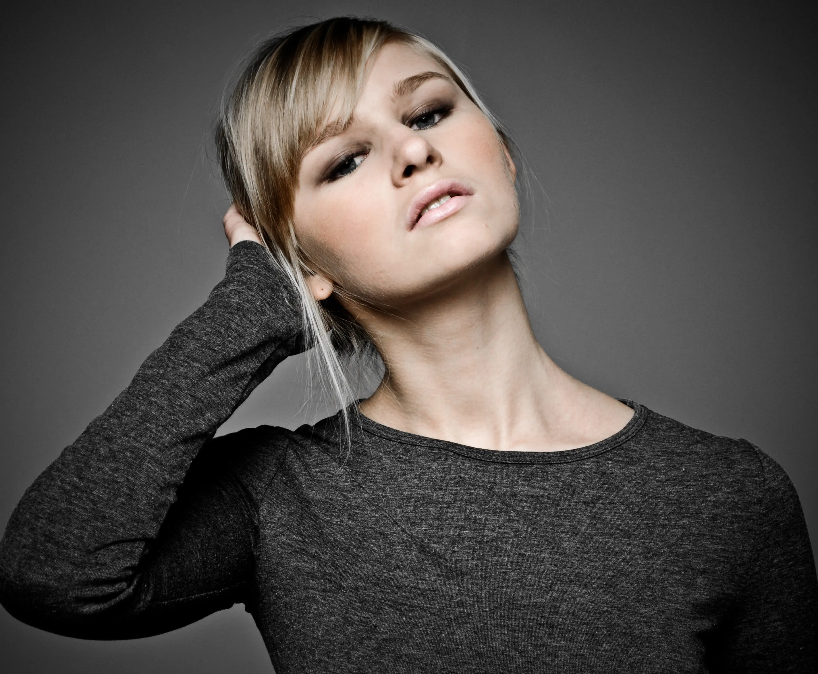 Ruth in casual grey top, confident studio portrait