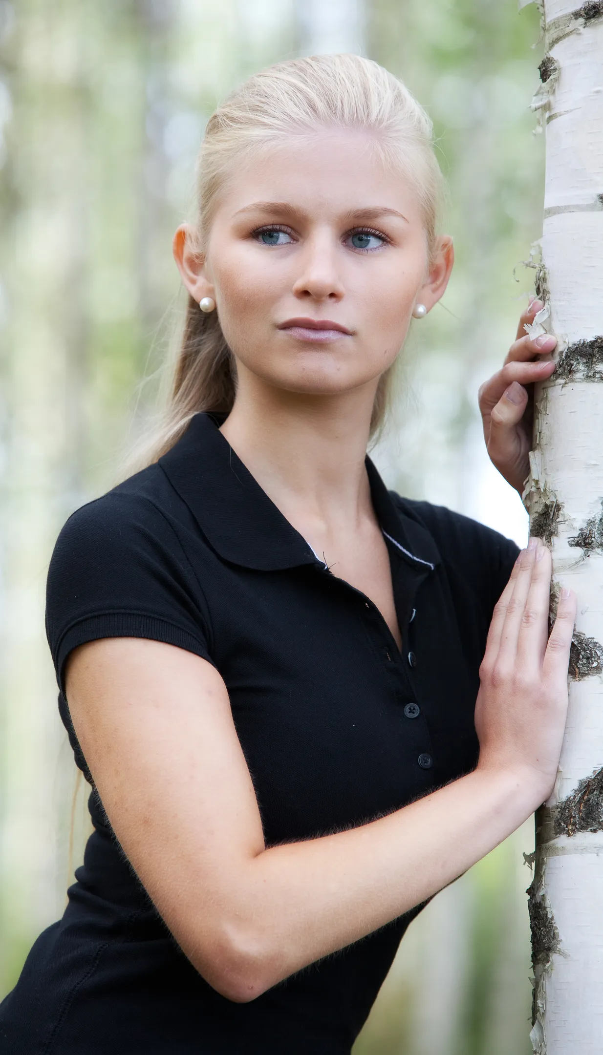 Ruth in natural portrait leaning against birch tree