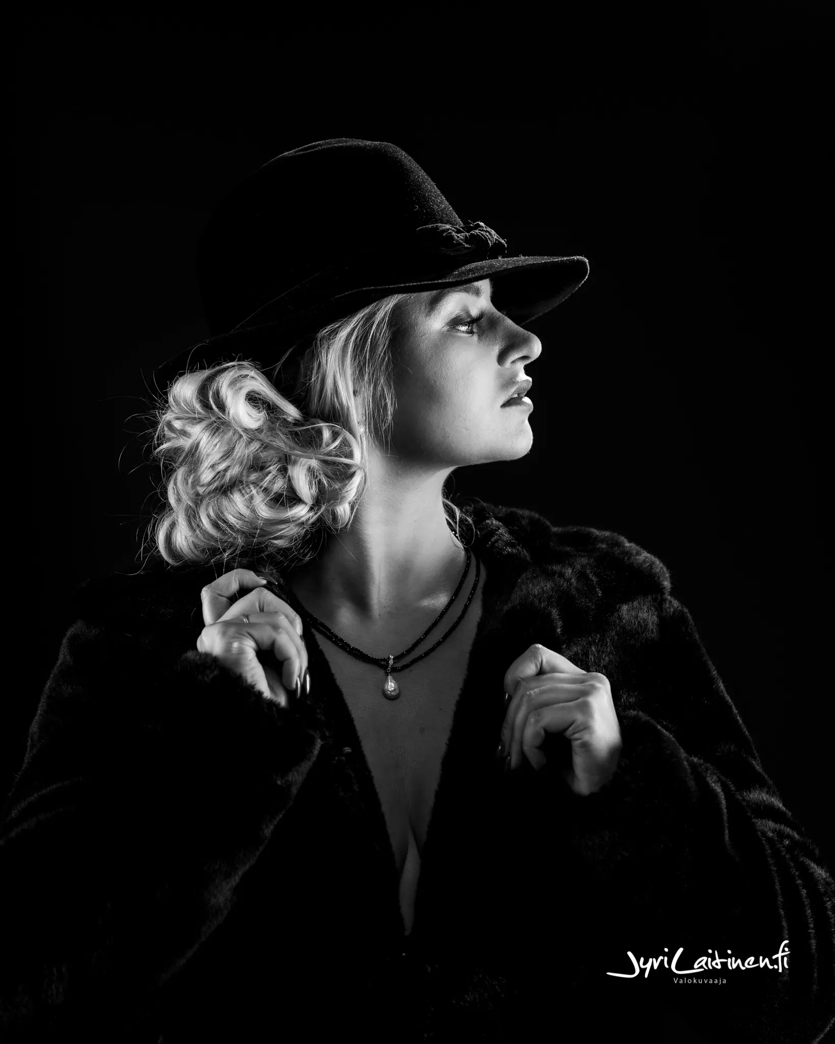 Ruth in a black and white portrait with a hat