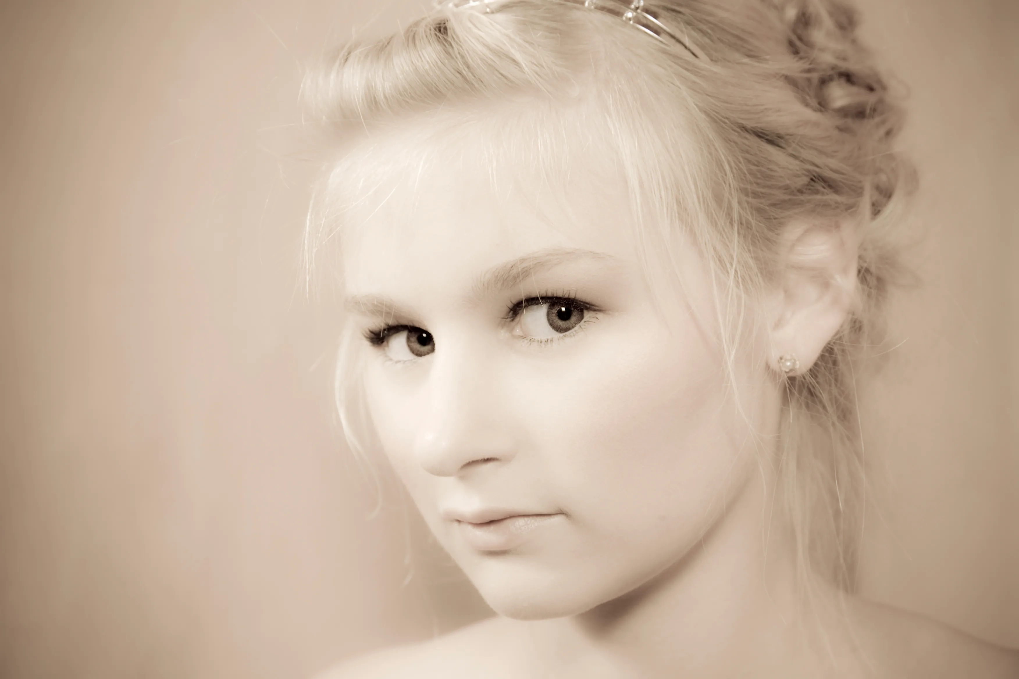 Ruth in soft sepia close-up with tiara, delicate beauty portrait