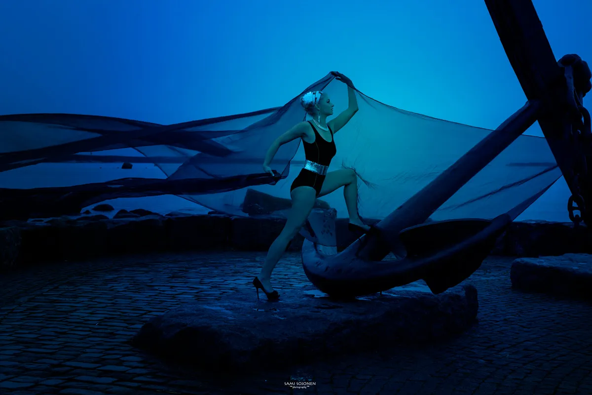 Ruth in white dress meditating in forest stream, serene