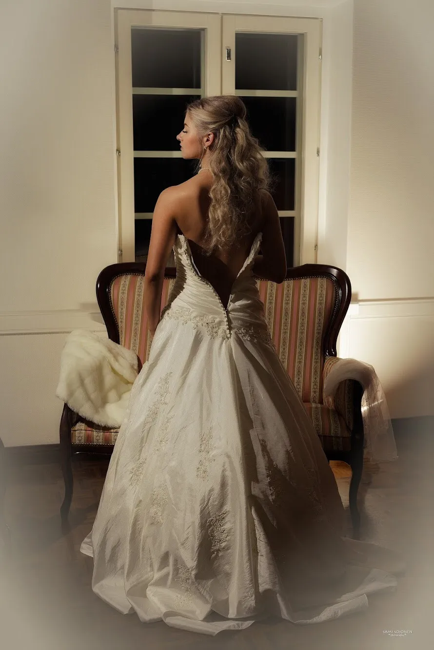 Ruth from behind in bridal gown in classic room setting