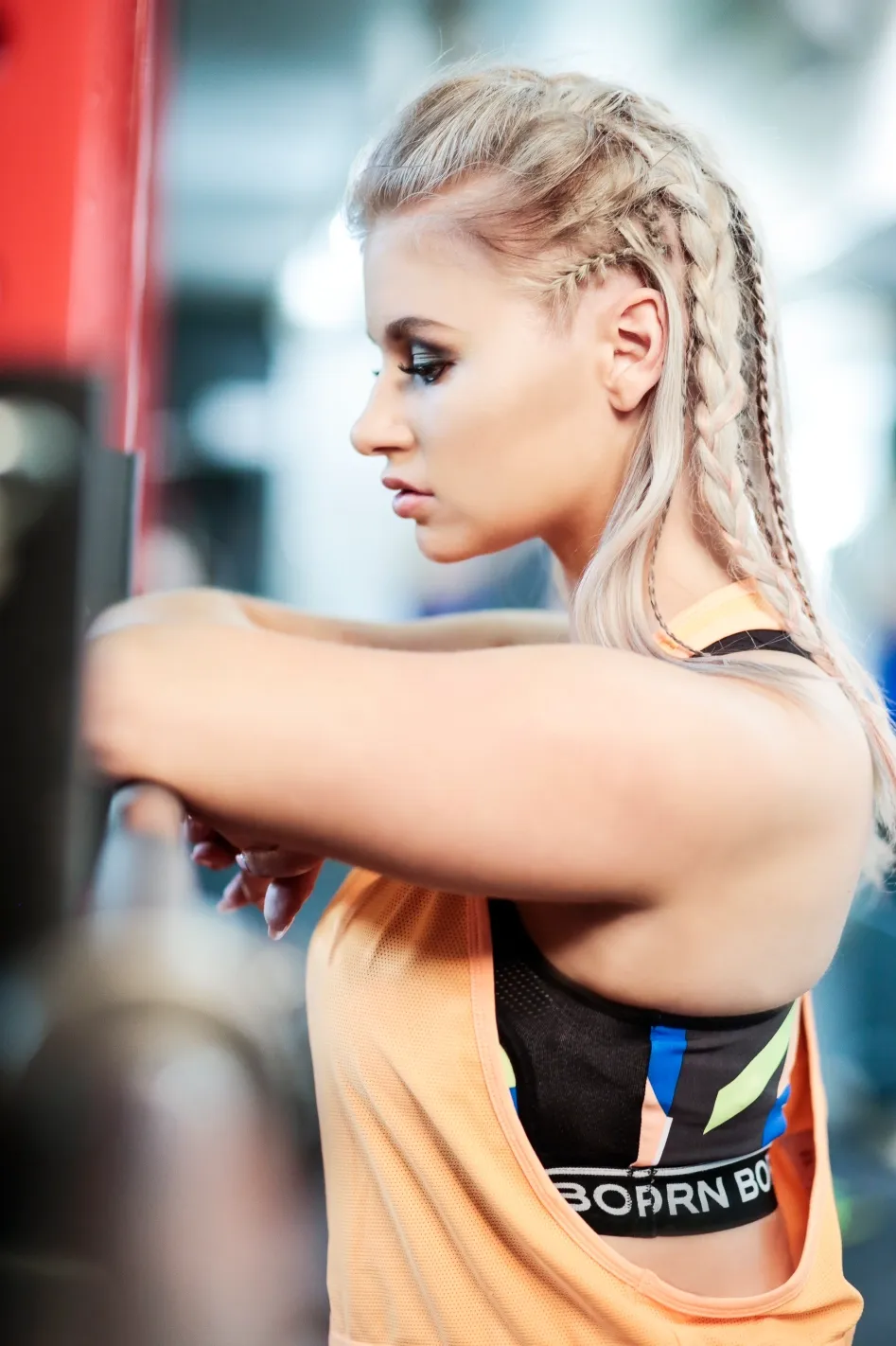 Ruth with braided hair working out at gym, athletic profile