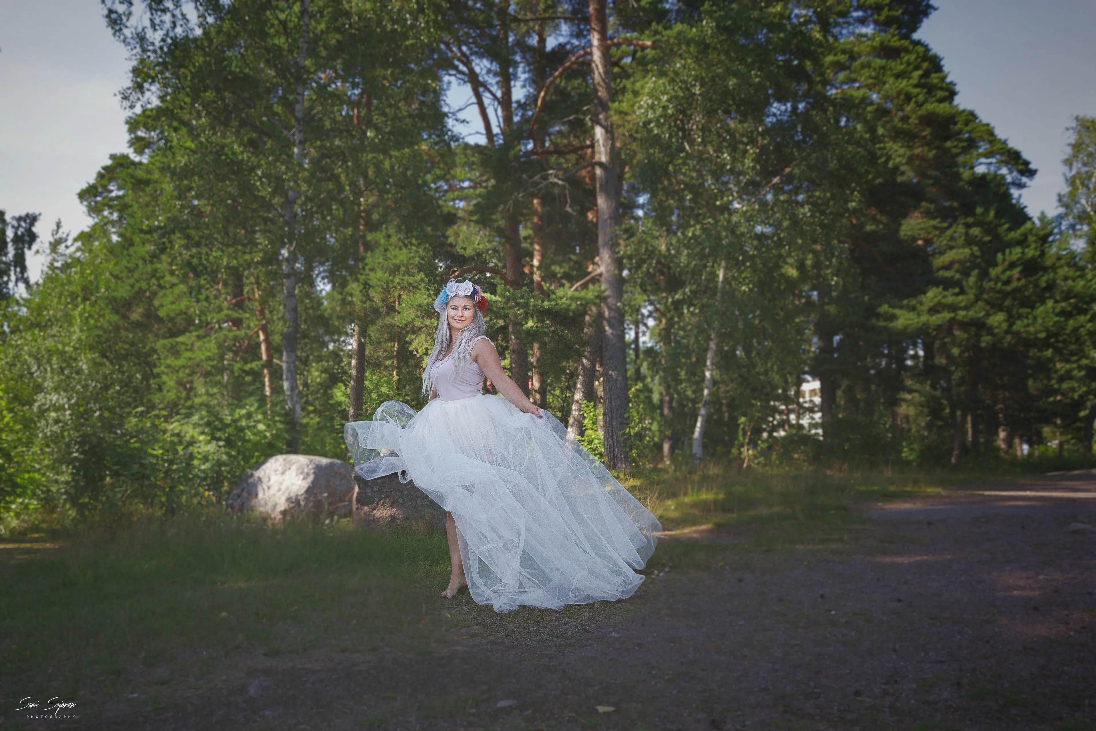 Ruth in tulle dress running through forest path at golden hour