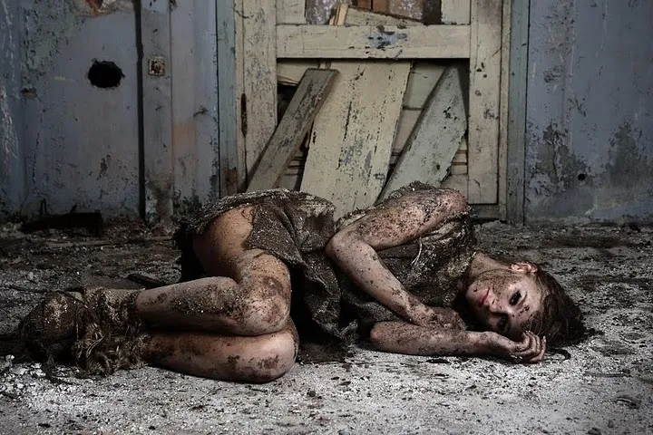 Ruth in dramatic character pose in abandoned interior