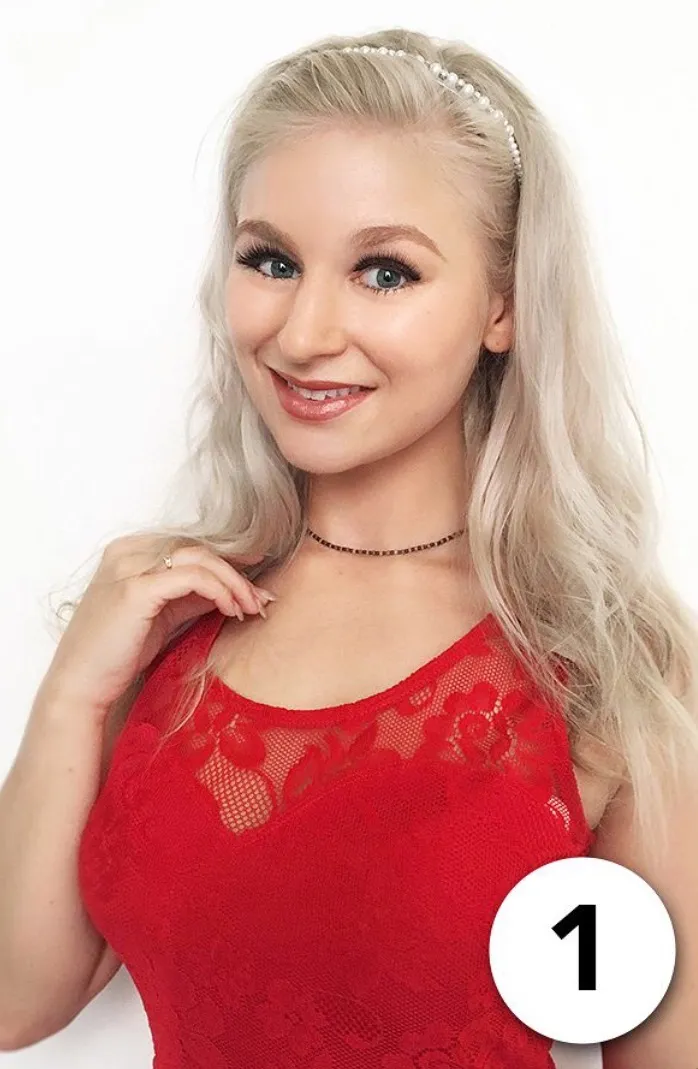 Ruth smiling in red lace top, bright headshot