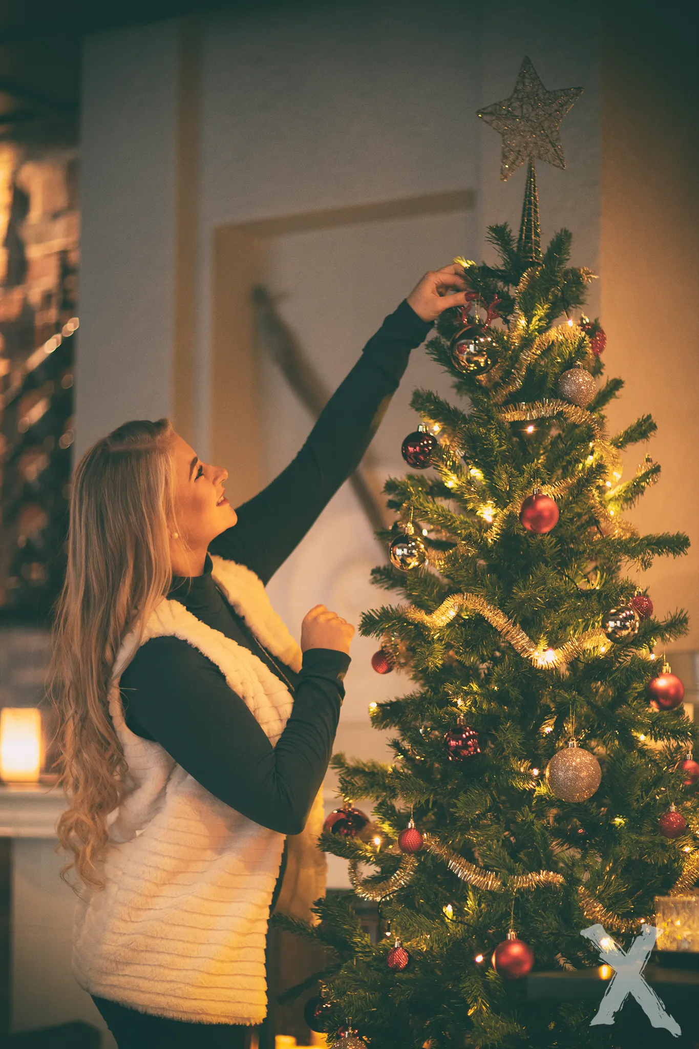 Ruth placing star on Christmas tree, warm holiday mood