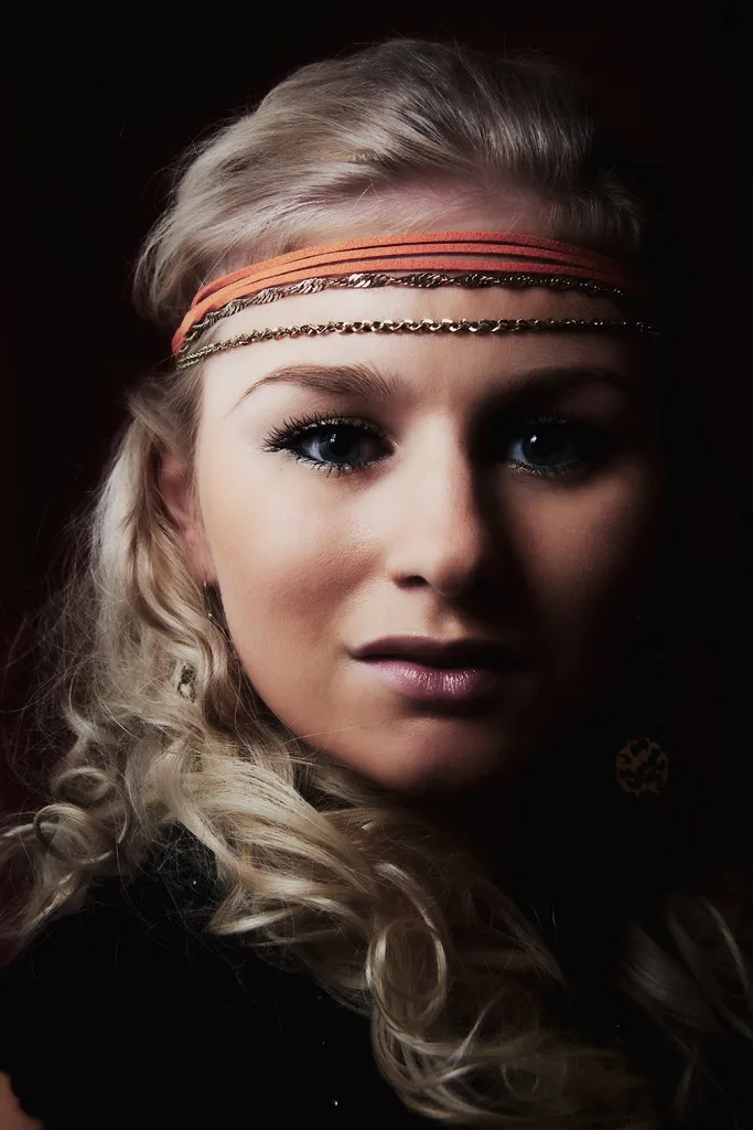 Ruth in dramatic low-key portrait with headband and curls