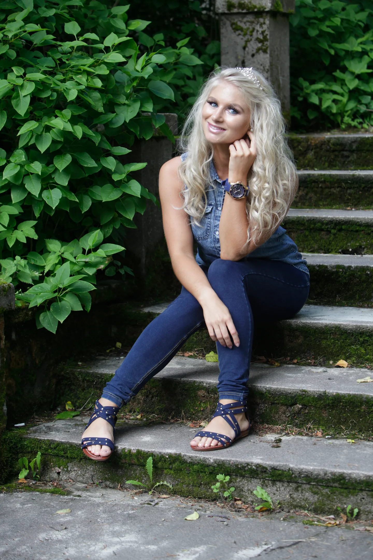 Ruth seated on garden stone steps in denim outfit